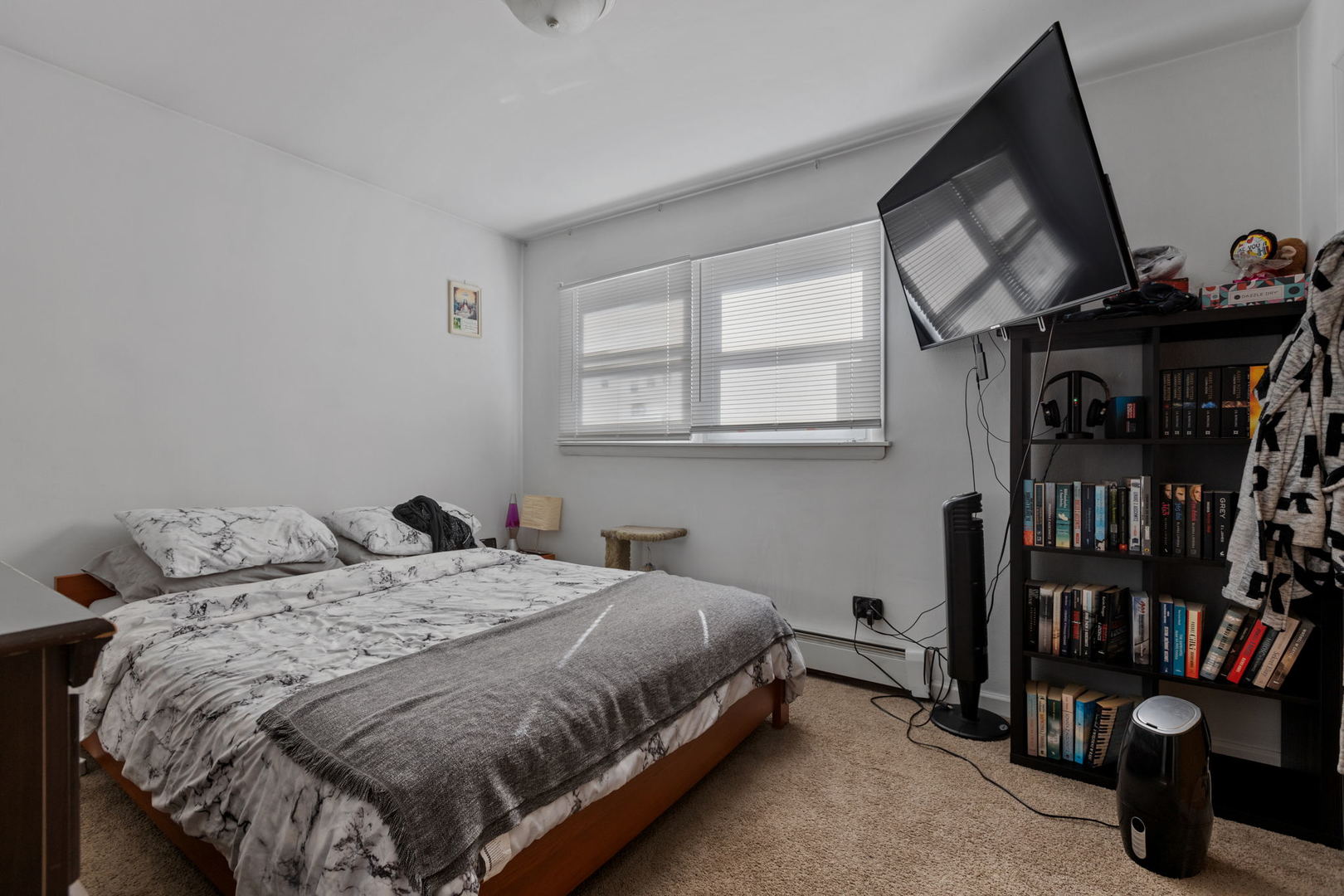 7535 Roberts Road Bridgeview, IL 60455 - Photo 17 of 30 a bedroom with a bed a book shelf and a window