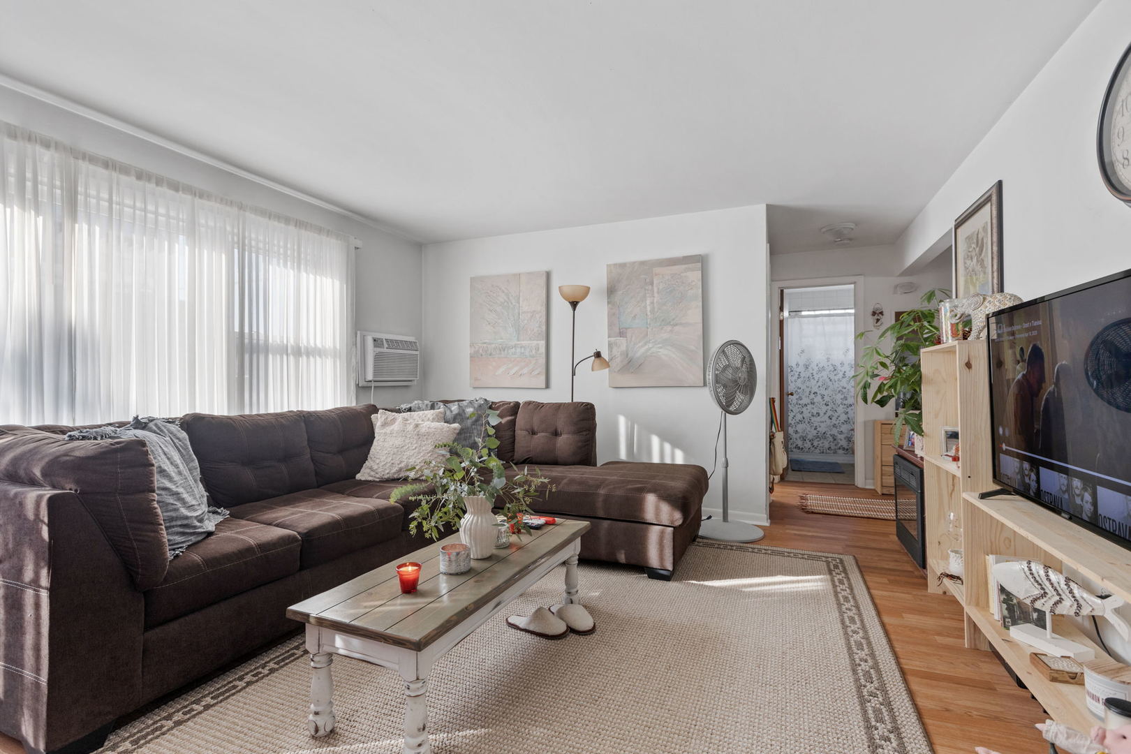 7535 Roberts Road Bridgeview, IL 60455 - Photo 7 of 30 a living room with furniture a window and a flat screen tv