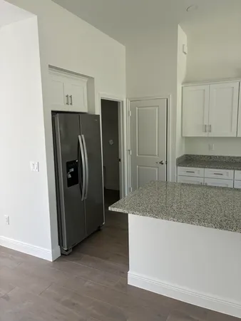 a view of wooden floor and windows in a room