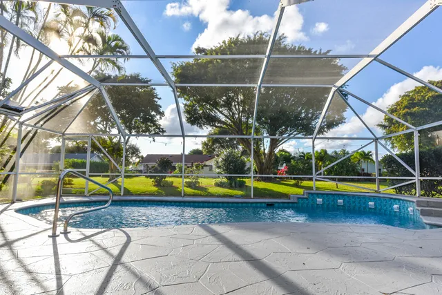 a view of a swimming pool with a yard