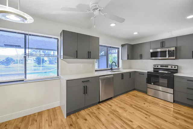 a kitchen with stainless steel appliances granite countertop a stove and a sink