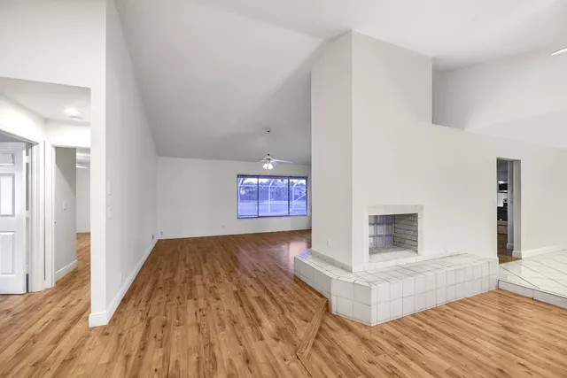 a view of an empty room and wooden floor