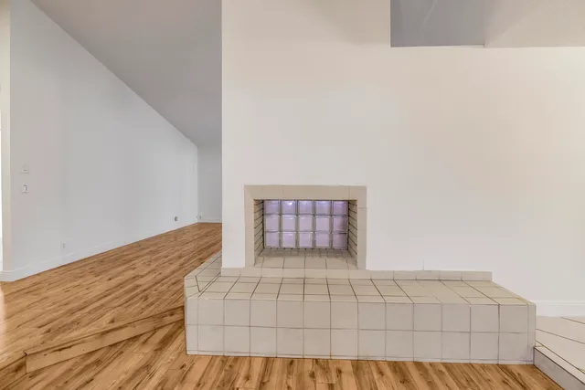 a view of an empty room and wooden floor