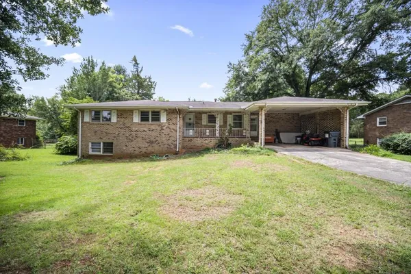 a view of a house with backyard porch and sitting area