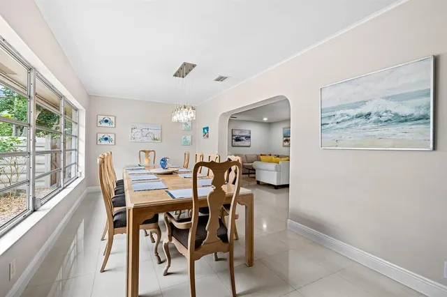 a view of a dining room with furniture and a large window