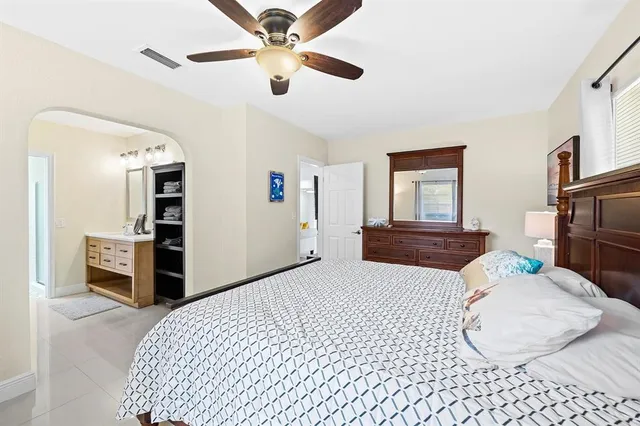a bedroom with a bed and dresser with mirror
