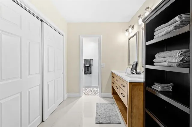 a spacious bathroom with a double vanity sink and a mirror