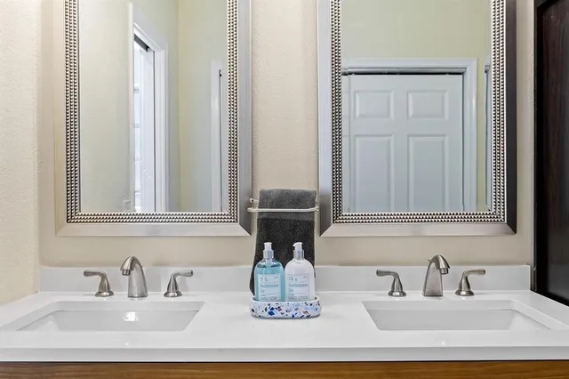 a bathroom with a double vanity sink