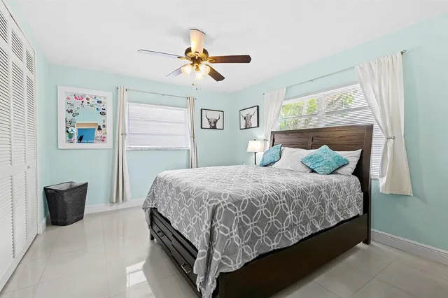 a bedroom with a bed and painting on the wall