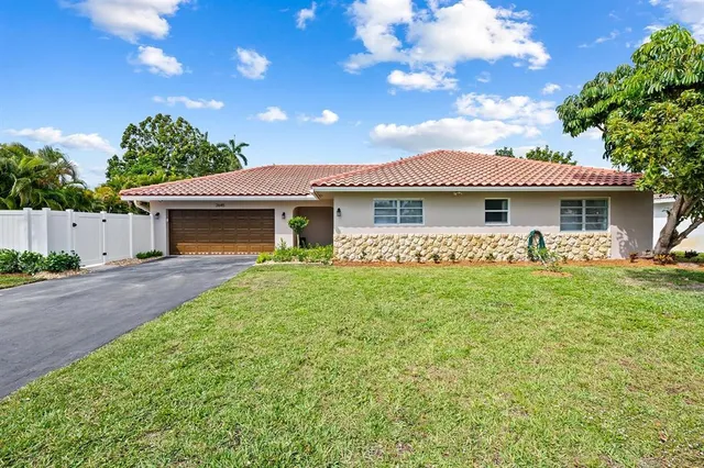 a front view of a house with a garden