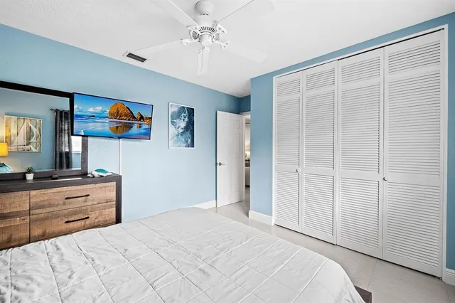 a bedroom with a bed and a dresser in it