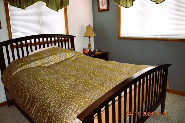 a bed sitting in a bedroom next to a window