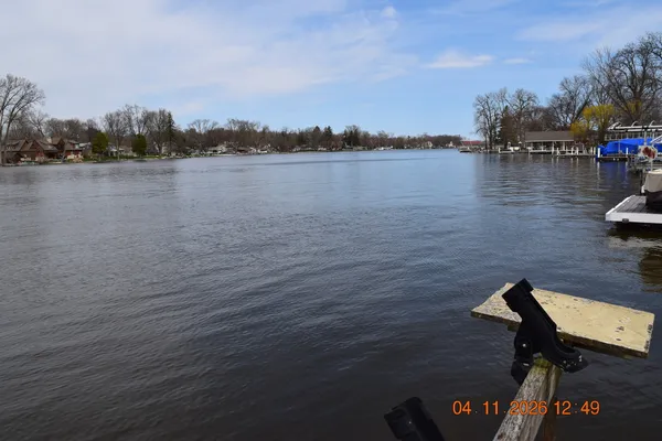 a view of a lake with houses in the back