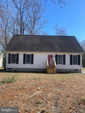 a house that has a tree in front of it