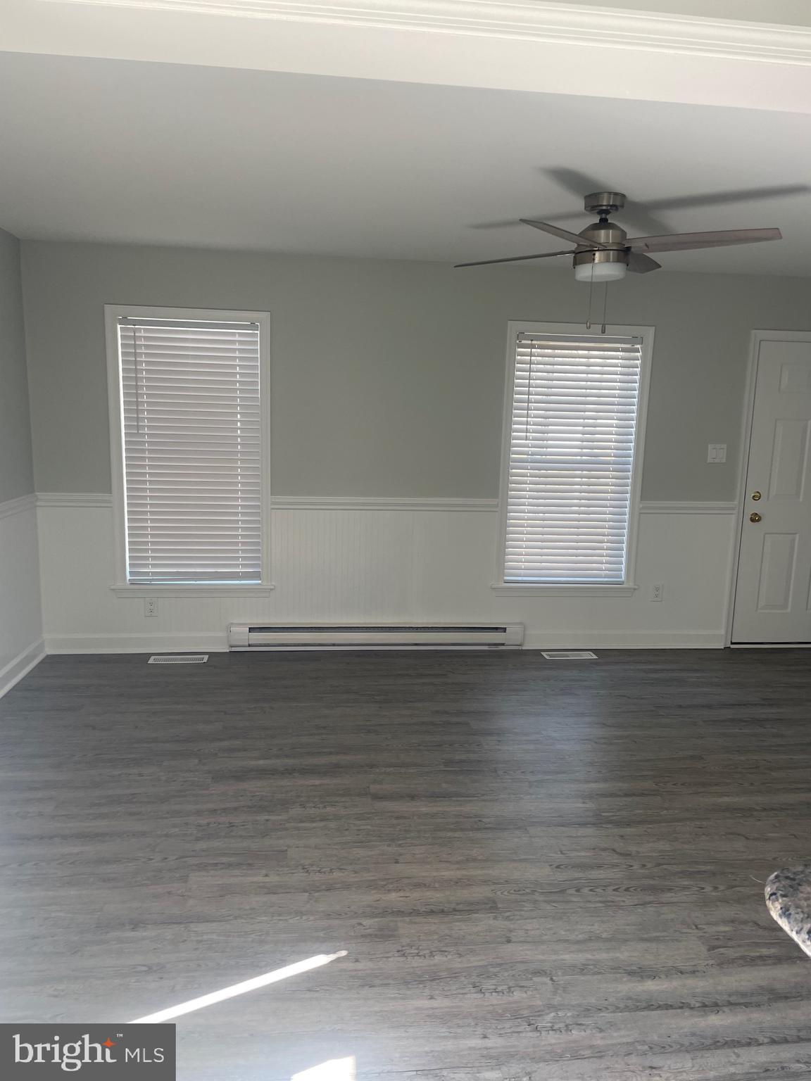 38901 Sea Gull Road Selbyville, DE 19975 - Photo 4 of 10 an empty room with wooden floor and windows