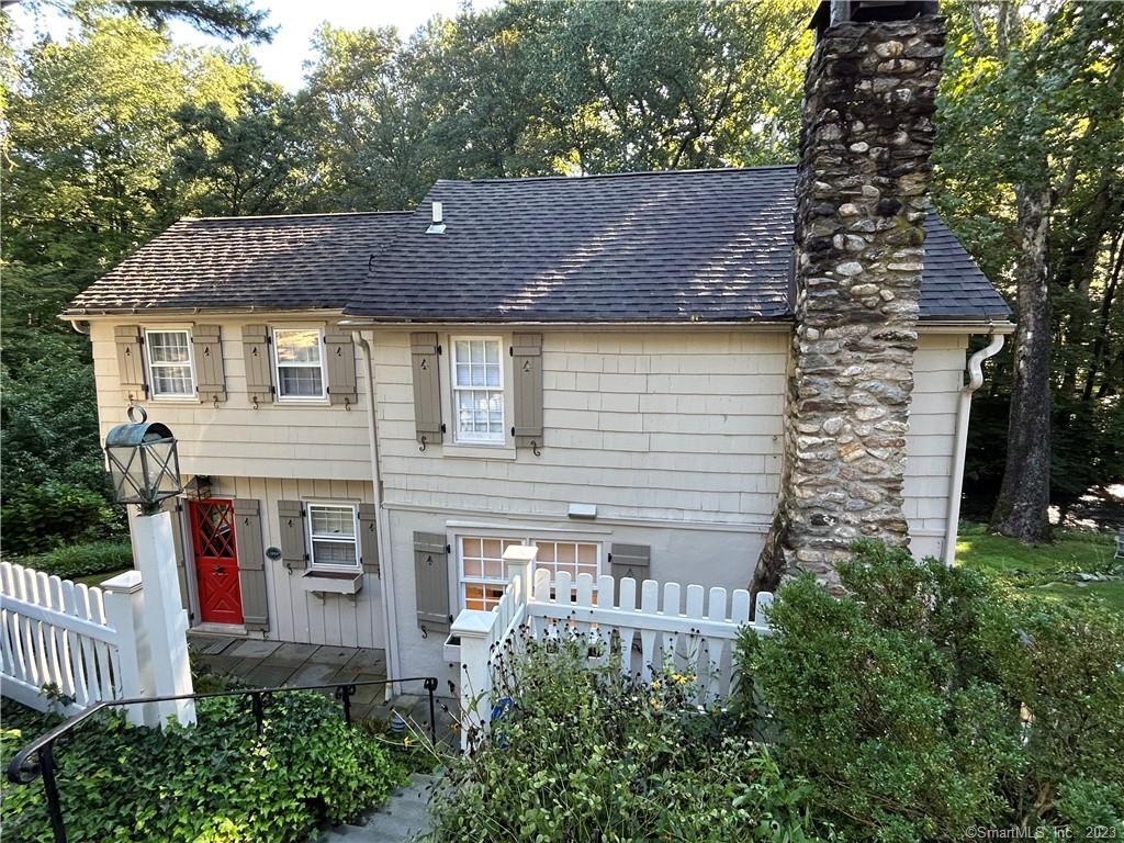 274 Mill Road New Canaan, CT 06840 - Photo 1 of 1 a house that has a tree in front of it