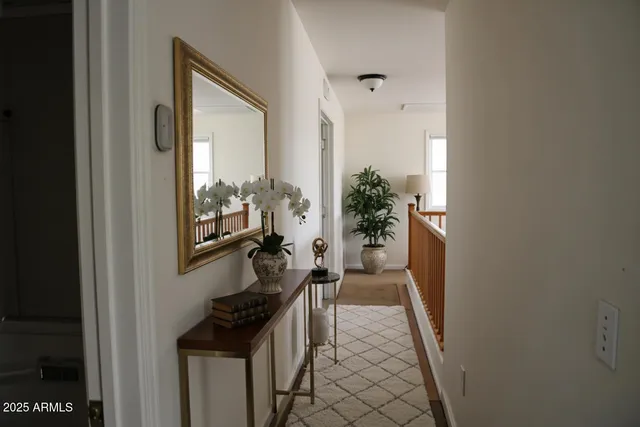 a view of a hallway to a livingroom with furniture