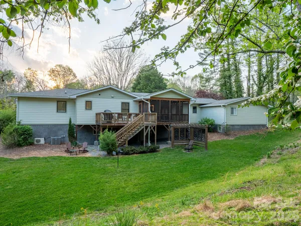 a view of a house with a yard and sitting area