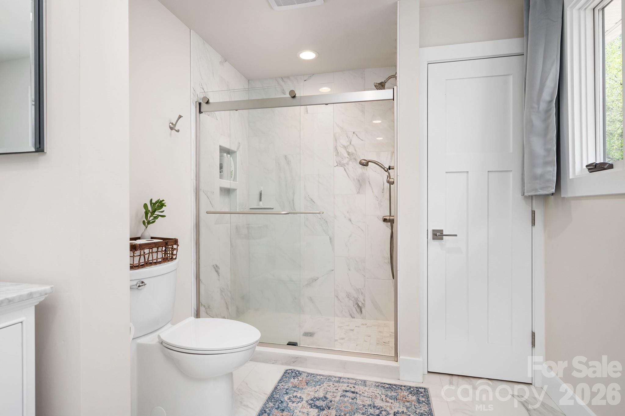 1048 Jenkins Valley Road Alexander, NC 28701 - Photo 13 of 25 a bathroom with a toilet and a shower