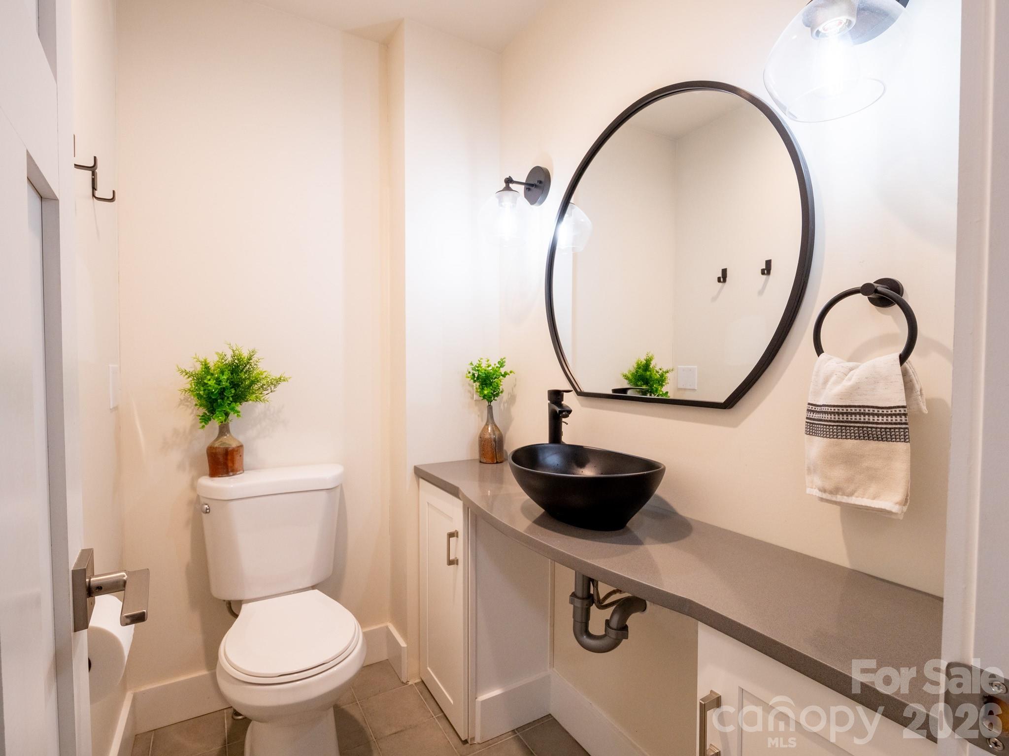 1048 Jenkins Valley Road Alexander, NC 28701 - Photo 15 of 25 a bathroom with a sink a toilet and a mirror