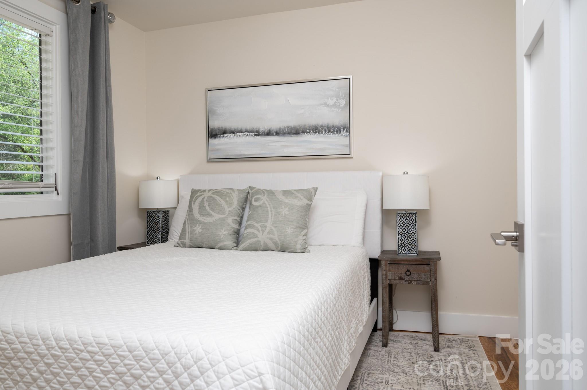 1048 Jenkins Valley Road Alexander, NC 28701 - Photo 16 of 25 a bedroom with a bed and a painting on the wall