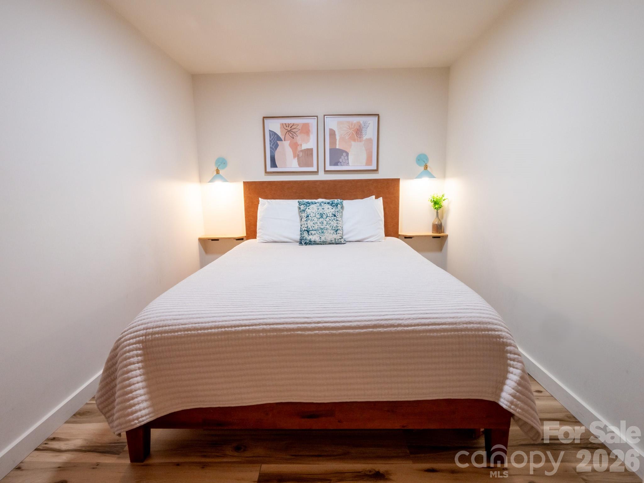 1048 Jenkins Valley Road Alexander, NC 28701 - Photo 20 of 25 a bedroom with a bed and a painting on the wall