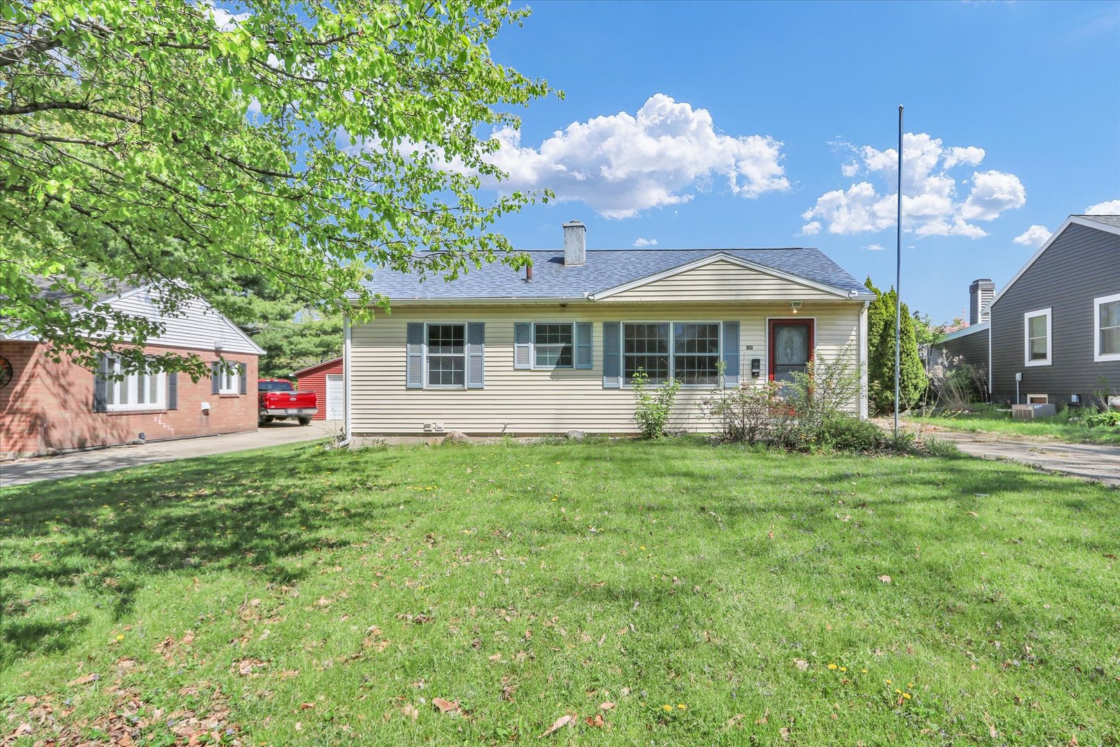 a view of a house with a yard patio and fire pit