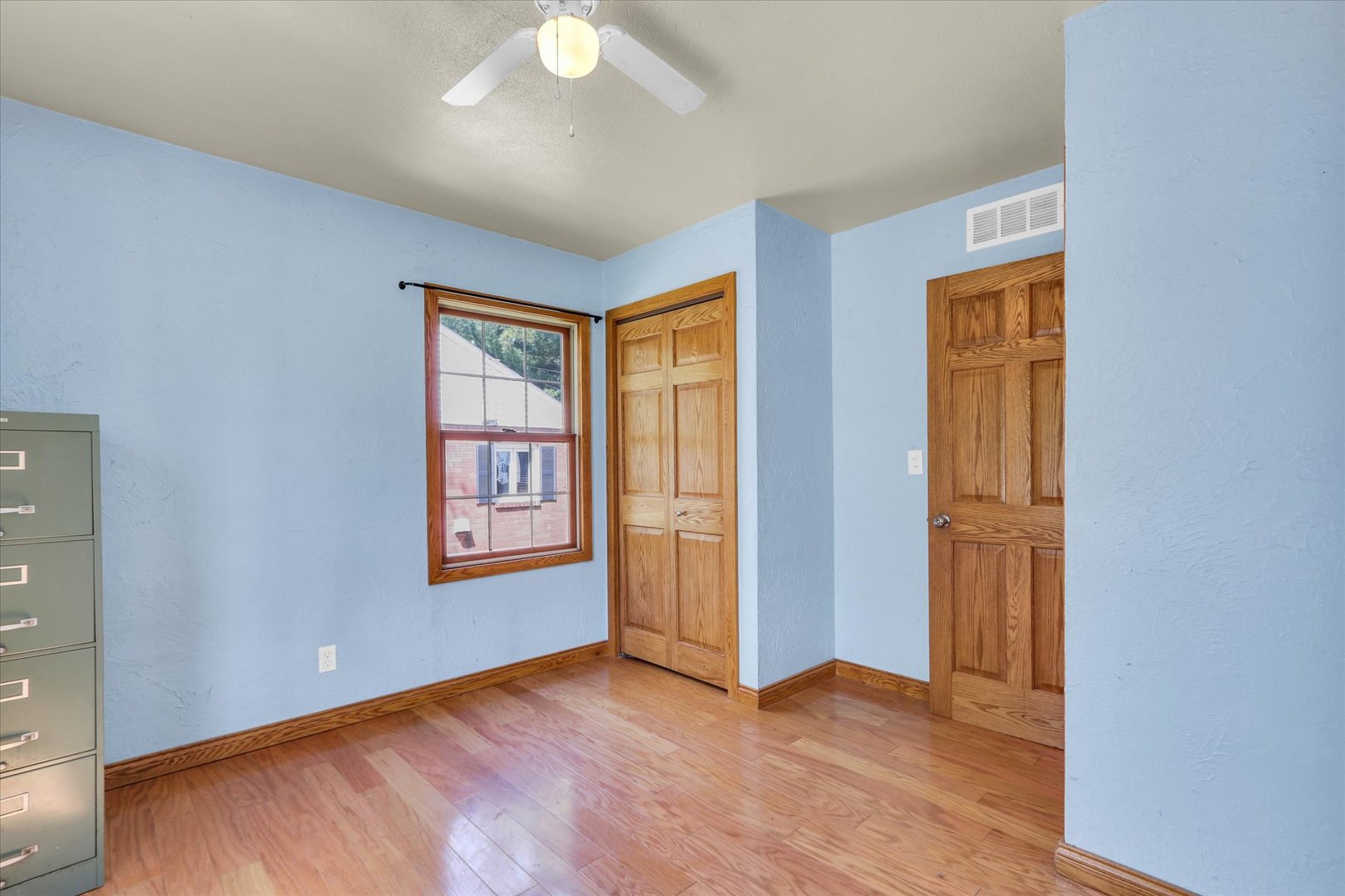 1108 Eastern Drive Urbana, IL 61801 - Photo 18 of 29 an empty room with wooden floor and windows
