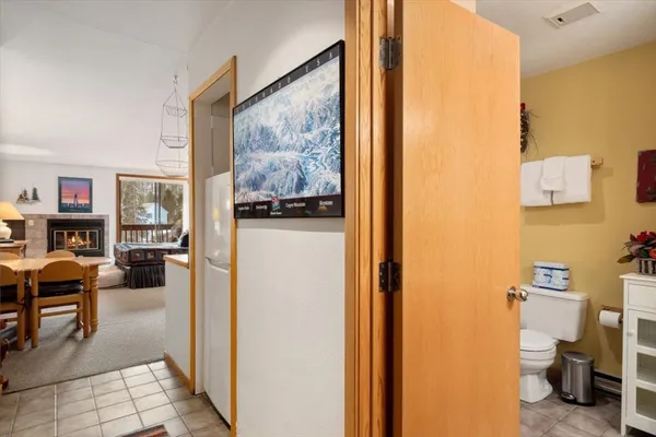 a view of a hallway with workspace and living room