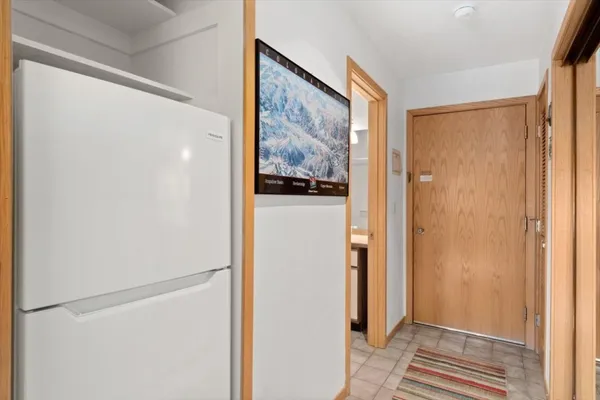 a view of a hallway with paintings on the wall