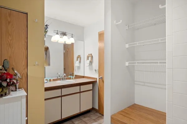 a bathroom with a double vanity sink and a mirror