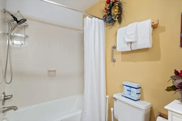 a bathroom with a shower a sink and a toilet