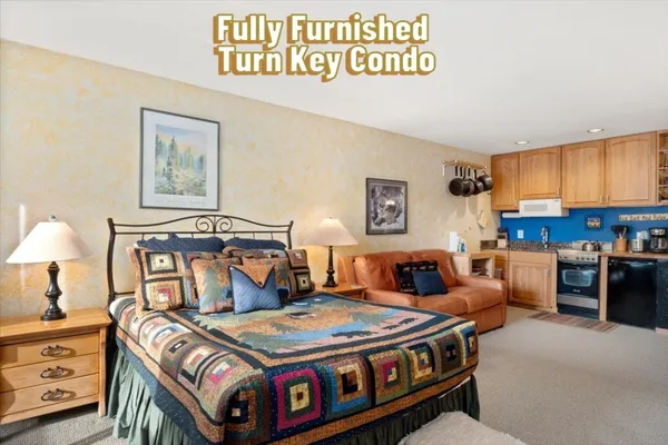 a bedroom with a bed a table and chair