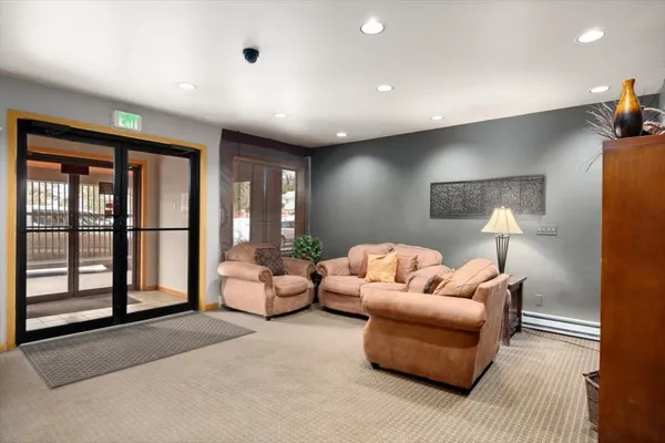 a living room with furniture and a lamp