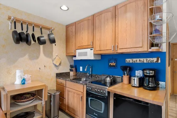 a kitchen with a sink cabinets and appliances