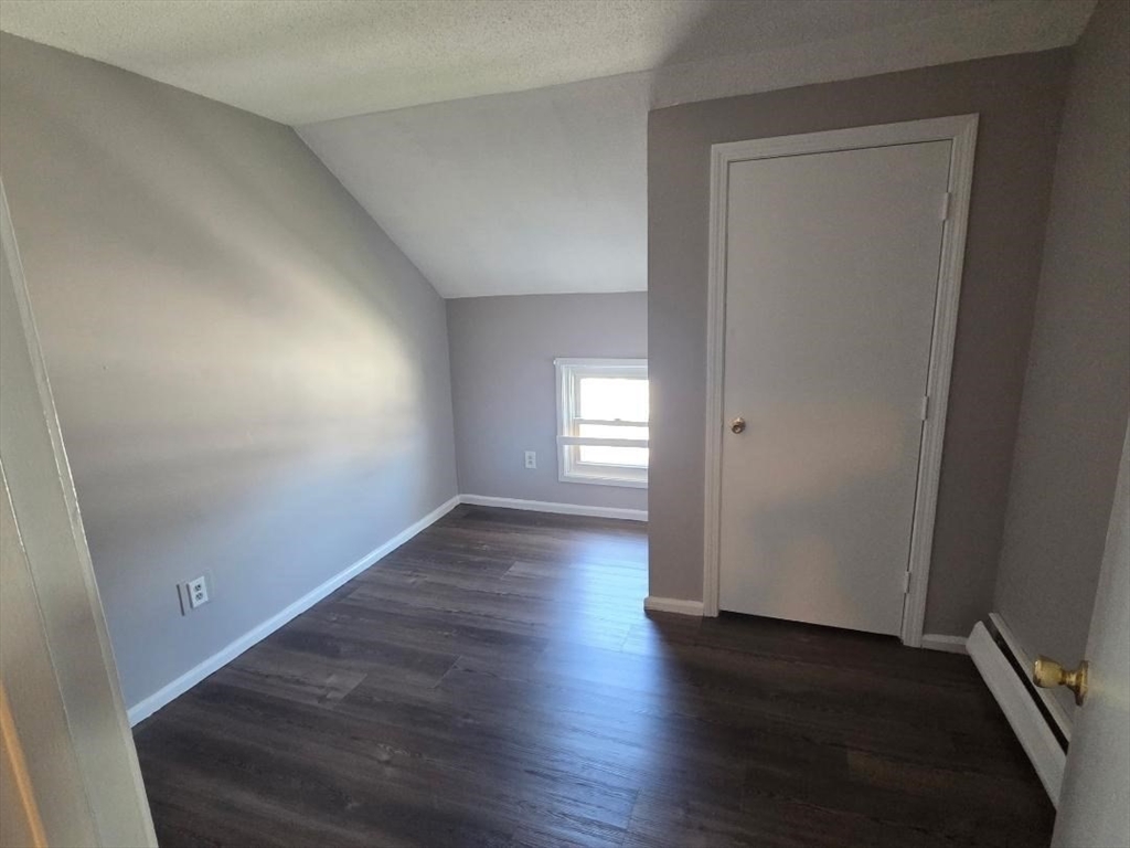 14 Carver Street, Unit 3 Fall River, MA 02721 - Photo 6 of 8 an empty room with wooden floor and windows