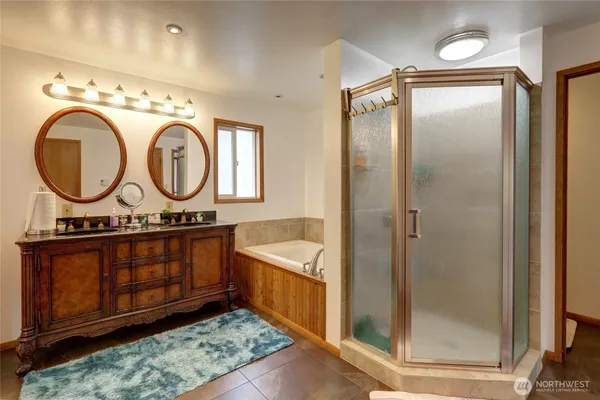 a bathroom with a sink a mirror and a shower