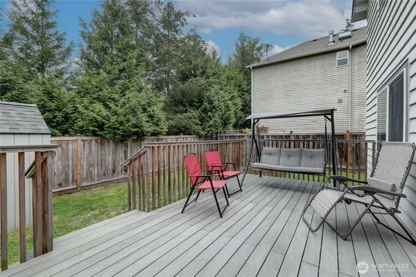 a view of a deck with wooden floor and outdoor seating