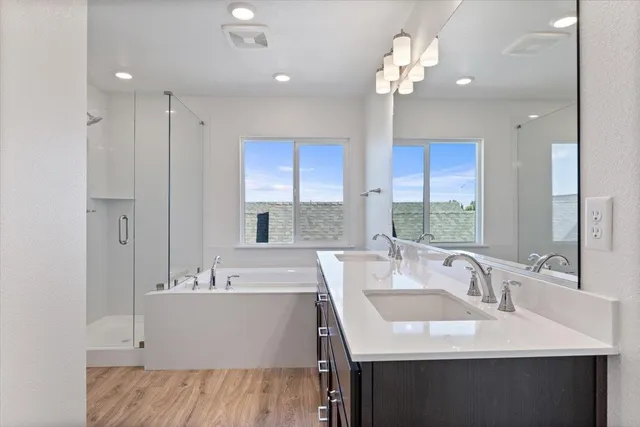 a bathroom with a tub sink and mirror