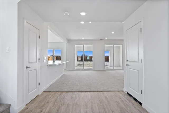 a view of a kitchen with wooden floor and a window