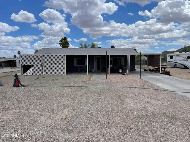 a view of a house with a backyard and sitting area