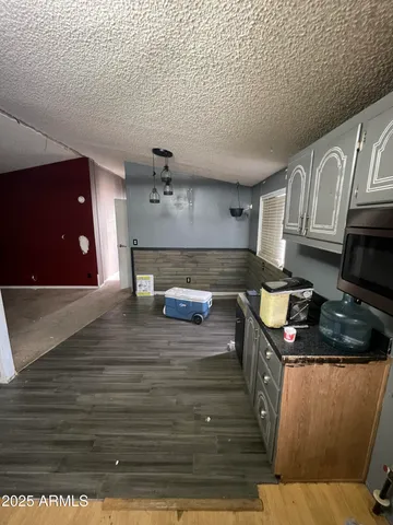 a kitchen with granite countertop a stove and cabinets