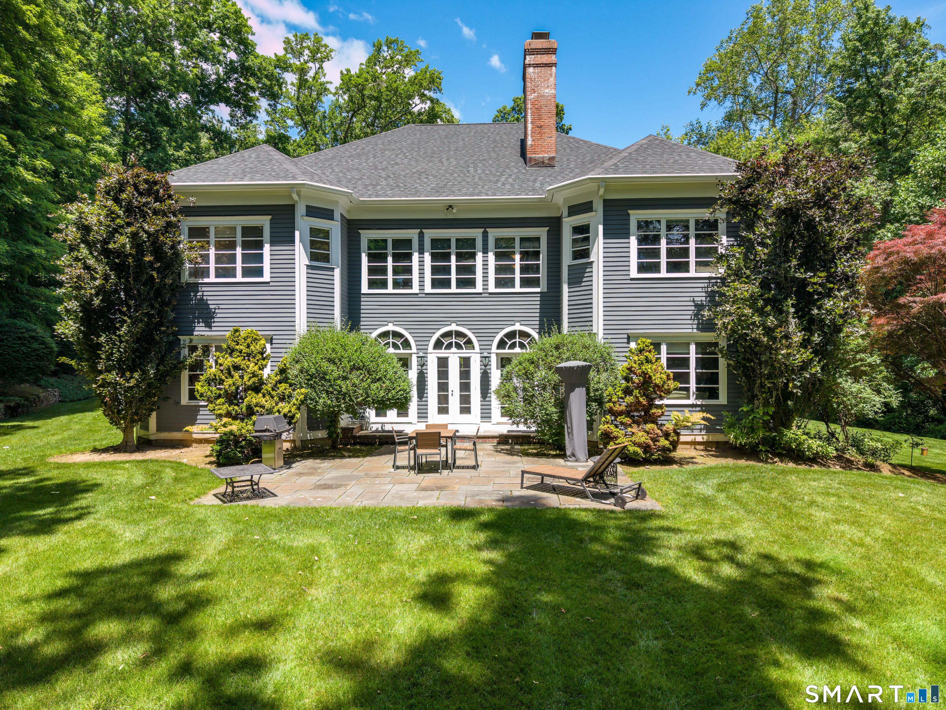 760 Smith Ridge Road New Canaan, CT 06840 - Photo 30 of 40 a view of a house with backyard sitting area and garden