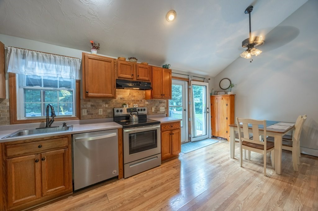 9 Boxberry Lane Rochester, MA 02770 - Photo 12 of 35 a kitchen with kitchen island granite countertop a sink cabinets and wooden floor