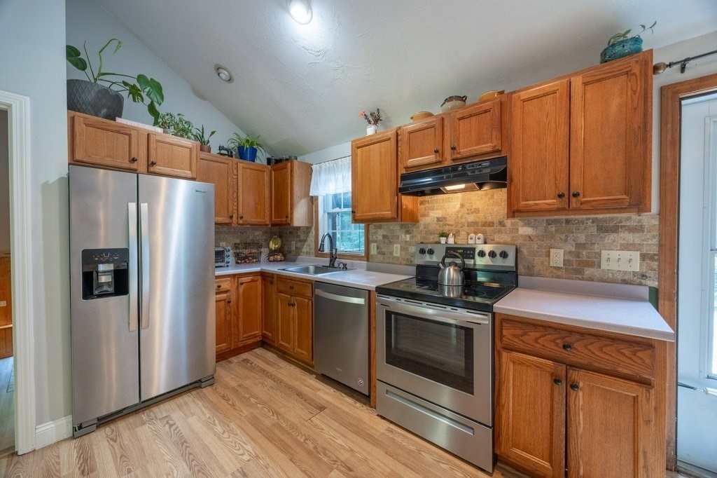 9 Boxberry Lane Rochester, MA 02770 - Photo 13 of 35 a kitchen with stainless steel appliances granite countertop a refrigerator stove and sink