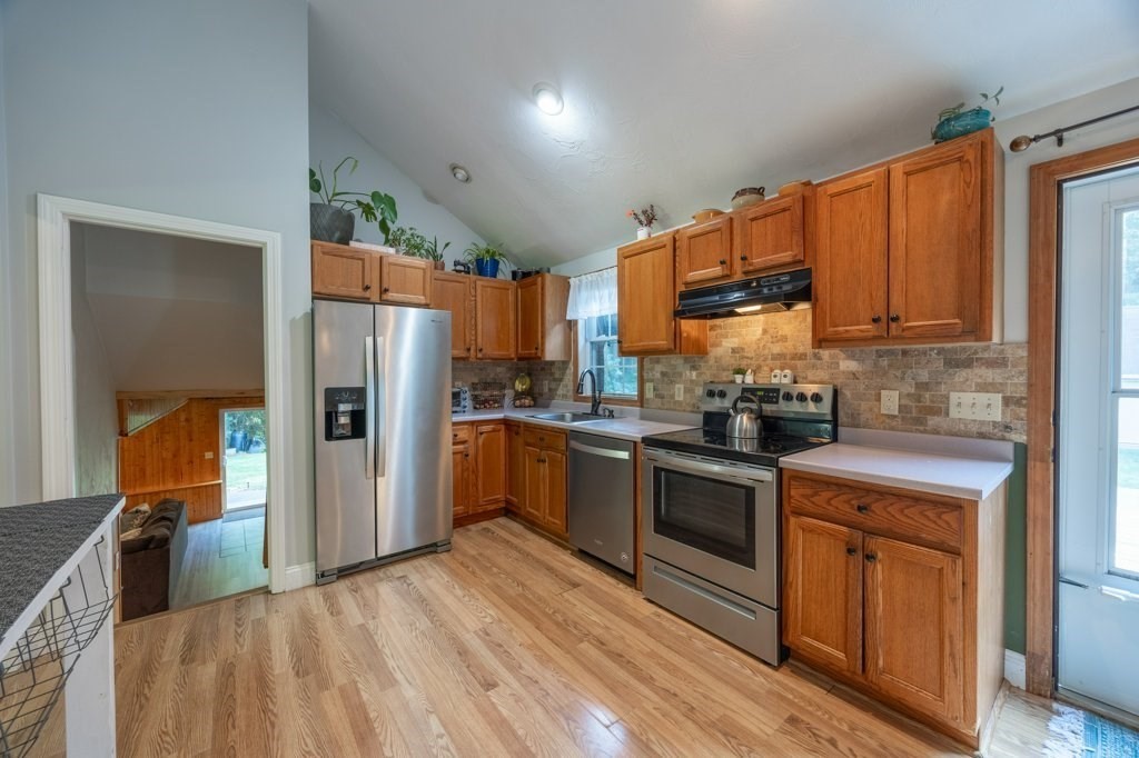 9 Boxberry Lane Rochester, MA 02770 - Photo 15 of 35 a kitchen with granite countertop a refrigerator stove and sink