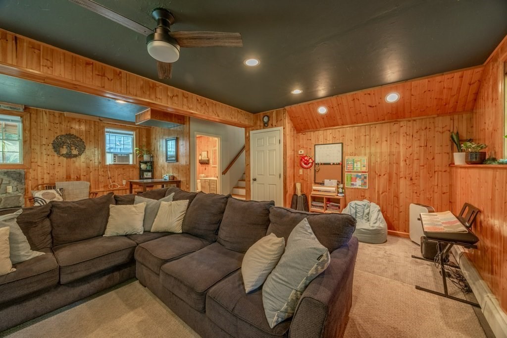 9 Boxberry Lane Rochester, MA 02770 - Photo 28 of 35 a living room with furniture ceiling fan and a rug