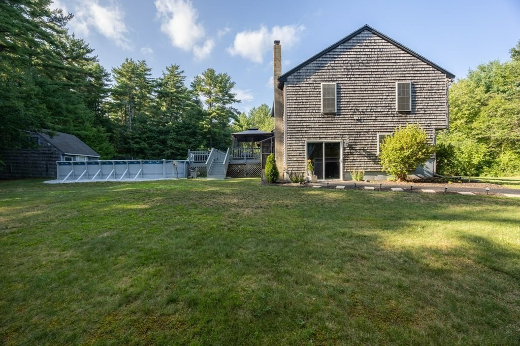 9 Boxberry Lane Rochester, MA 02770 - Photo 4 of 35 a front view of a house with a yard