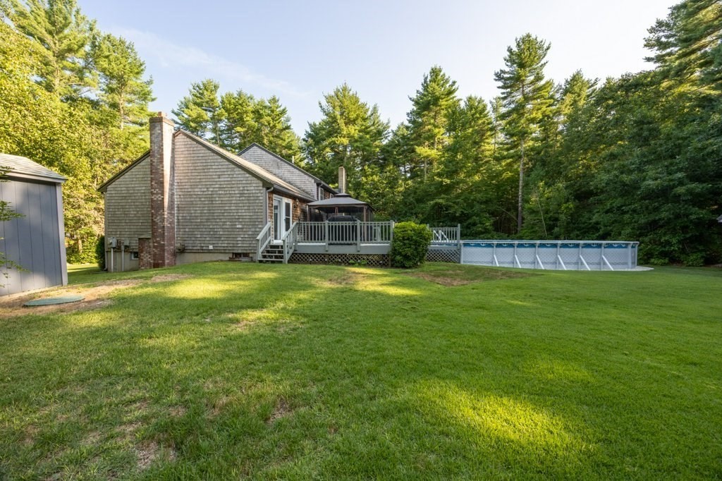 9 Boxberry Lane Rochester, MA 02770 - Photo 8 of 35 a view of swimming pool with garden and trees