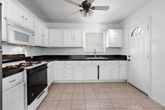 a kitchen with granite countertop cabinets and stainless steel appliances